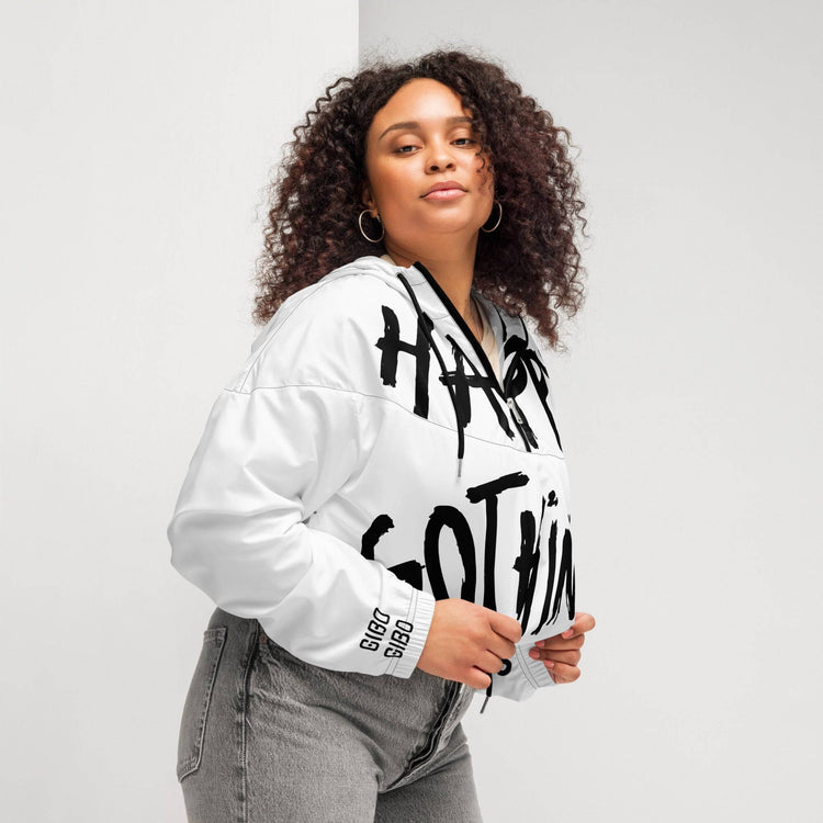 Plus-size model in white cropped windbreaker with bold black text, showcasing adjustable drawcords and a relaxed fit for versatile wear.