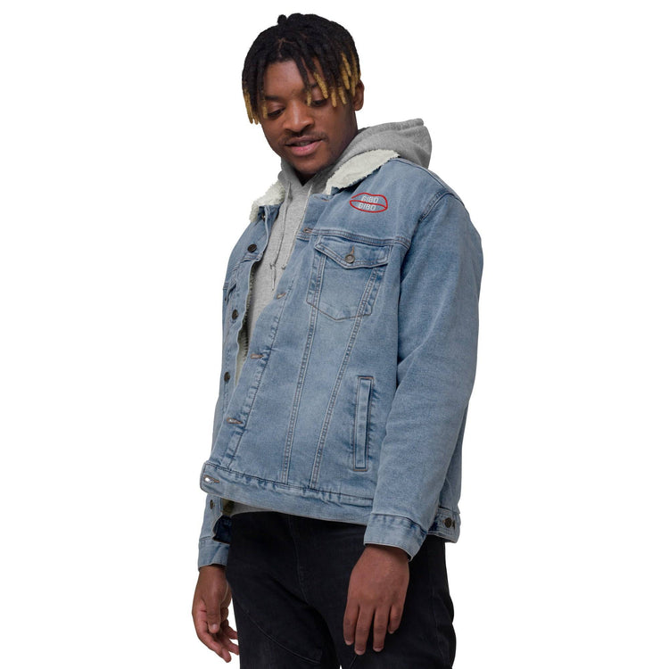 Light blue denim sherpa jacket with white wool lining, red chest logo, and dual chest pockets. Modeled with a casual hoodie underneath.